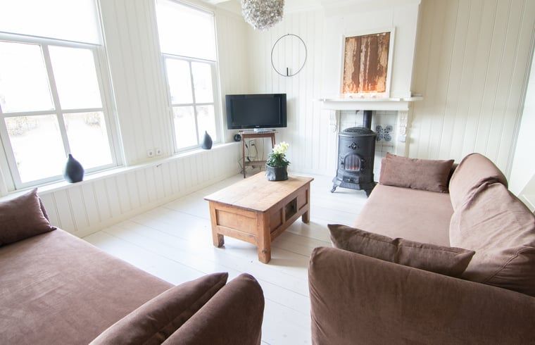 Cottage in Paesens, cozy living room with wood stove in the Frisian countryside.