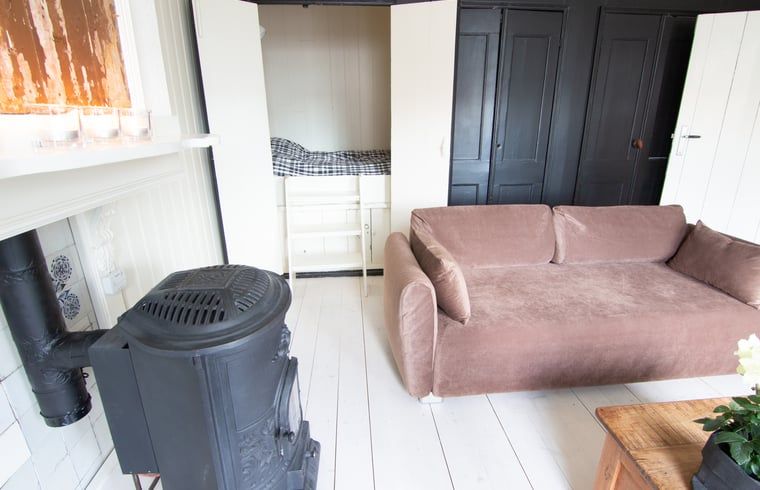 Cottage in Paesens, cozy sitting area with wood stove in Friesland.