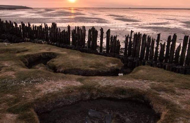 Cottage in Paesens, unique coastline of Friesland at sunset.