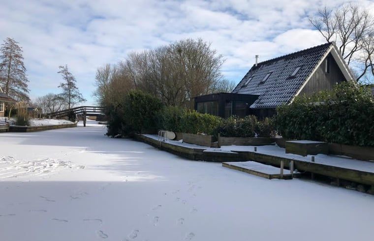 Winterlandschap bij Vakantiehuisje in Bartlehiem met besneeuwd kanaal op het Friese platteland.
