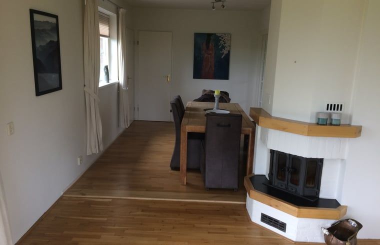 Esszimmer mit Kamin im Ferienhaus in Nes, Friesland, fuer eine warme Atmosphaere.