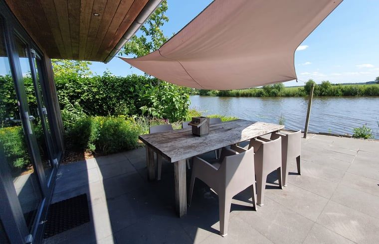 Enjoy the waterfront terrace at Cottage in Jannum near Dokkum in the Frisian countryside in Friesland.