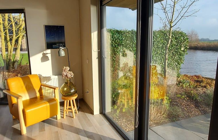 Sunny reading corner overlooking the garden at Cottage in Jannum near Dokkum, Friesland.