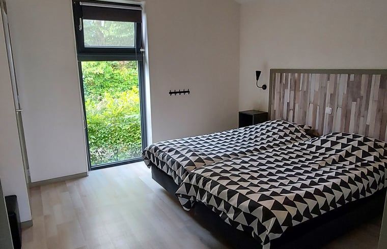 Cozy bedroom overlooking the garden in Cottage in Jannum near Dokkum, Friesland.