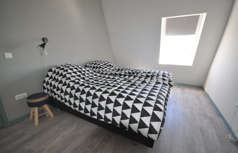 Bedroom with double bed in Cottage in Jannum near Dokkum, vacation home in Friesland.