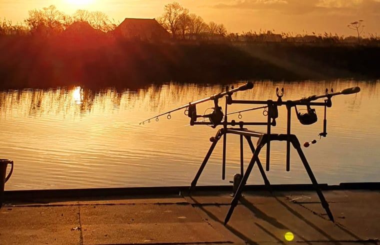 Fishing at sunset by the water at cottage in Jannum near Dokkum, Friesland.
