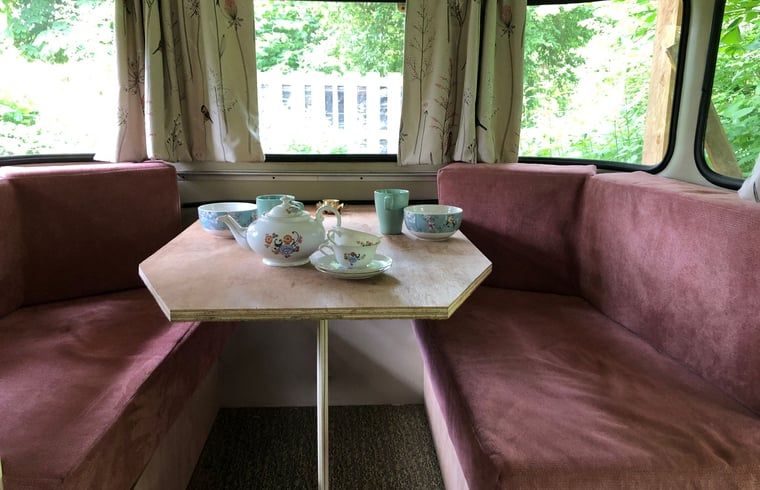 Cozy indoor area of Holiday Home in Dreumel, Gelderland with comfortable seating area and view of green surroundings.