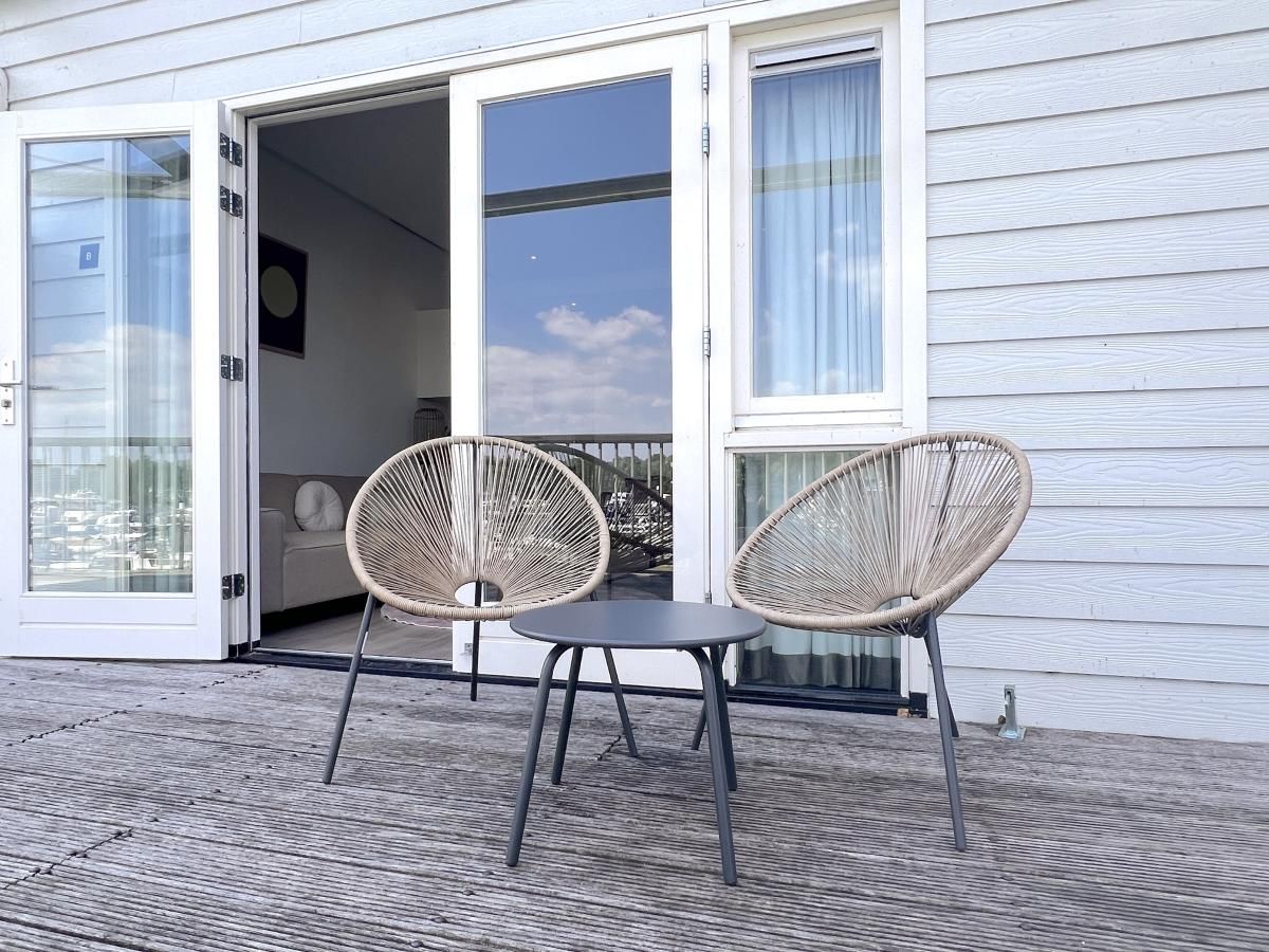 Terrassenstuehle im Ferienhaus Havenzicht in Maasbommel, mit Blick auf den Jachthafen in Rivierengebied, Gelderland.