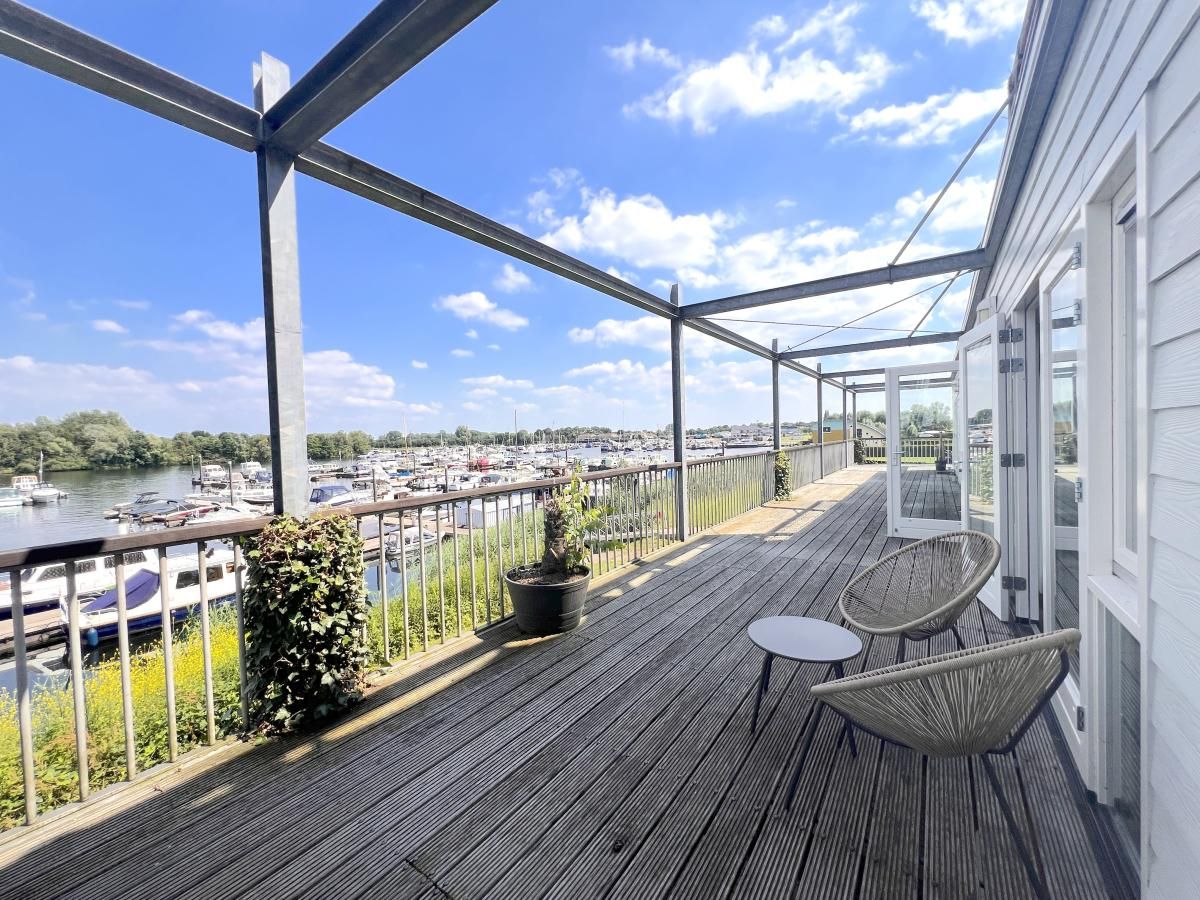 Grosszuegige Terrasse mit Blick auf den Yachthafen im Ferienhaus Havenzicht, Maasbommel, Rivierengebied, Gelderland.