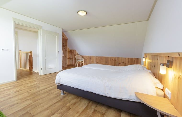 Sfeervolle slaapkamer in Vakantiehuis in Zelhem met houten details, Achterhoek, Gelderland.