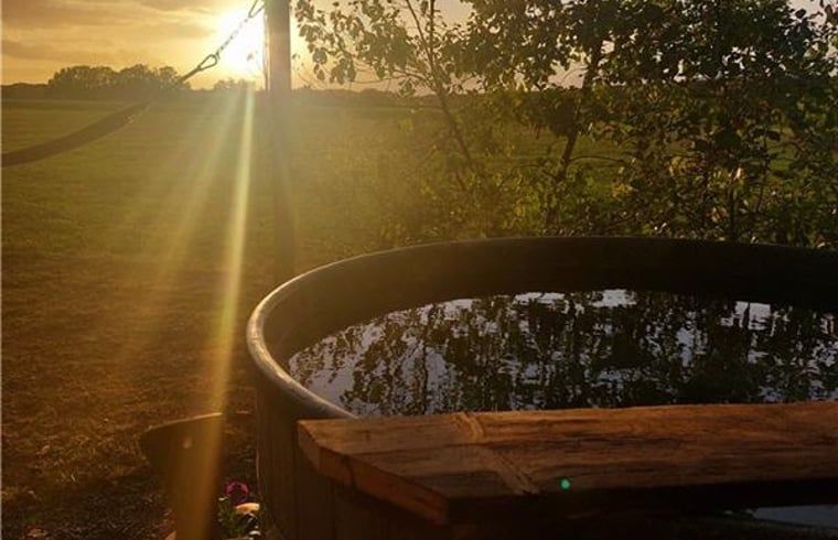 Enchanting sunset at Cottage in Westendorp, bed and breakfast in Westendorp, with a serene hot tub.