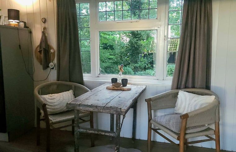 Dining area overlooking the garden in Holiday home in Vragender, Achterhoek, Gelderland. Enjoy meals in nature.