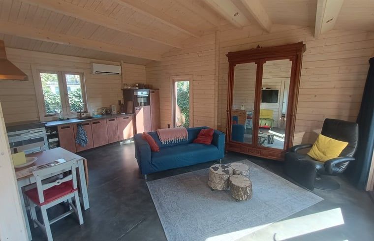 Cozy living room in cottage in Lochem with comfortable seating area in Gelderland.