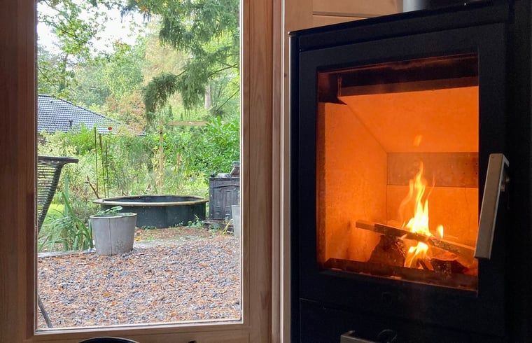 Cozy fireplace in Cottage in Lochem, Achterhoek, overlooking the garden.