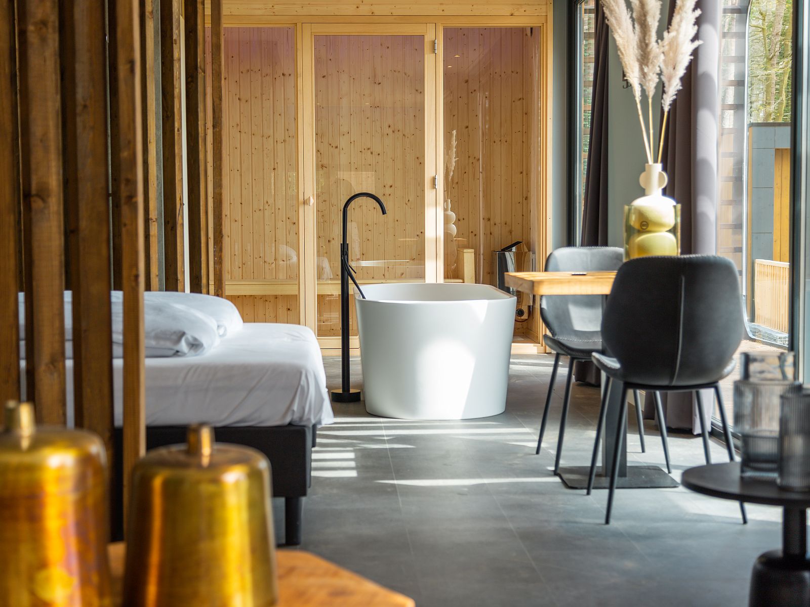 Open living room of Chalet in Lochem with dining area and natural light, Achterhoek, Gelderland.