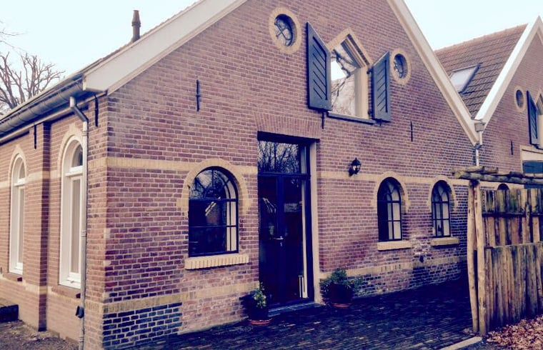 Huisje in Lochem, een charmant vakantiehuis in de Achterhoek, Gelderland, met authentieke bakstenen gevel en landelijke uitstraling.