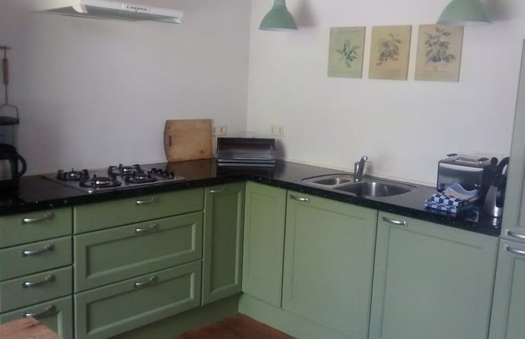 Cozy kitchen in Holiday home in Vorden, located in Achterhoek, Gelderland. Enjoy the modern amenities in this vacation home.