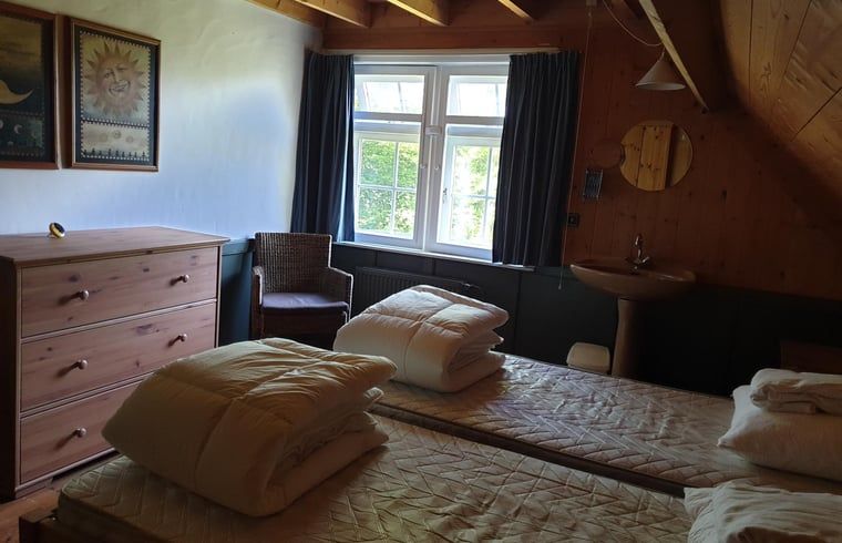 Attractive bedroom in Holiday Home in Vorden, Achterhoek, Gelderland with wooden interior and view of green surroundings.