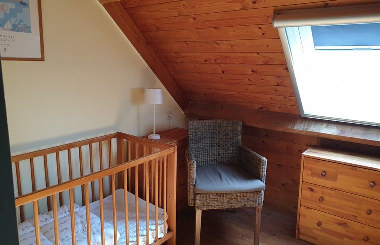 Cozy nursery in Holiday Home in Vorden, Achterhoek, Gelderland with wooden interior and a crib for a cozy family vacation.