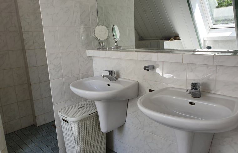 Double sinks in the bathroom of cottage in Warnsveld, Achterhoek, with large mirror.