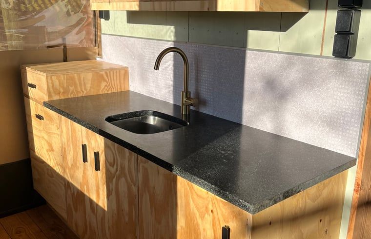Modern kitchen in Cottage in Winterswijk - Meddo, vacation home in the Achterhoek region, Gelderland. Stylish design with wooden cabinets and natural stone countertops.