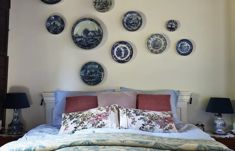 Attractive bedroom in Cottage in Voorst, Oude IJsselstreek, with artistic wall decorations and cozy furnishings, Achterhoek, Gelderland.