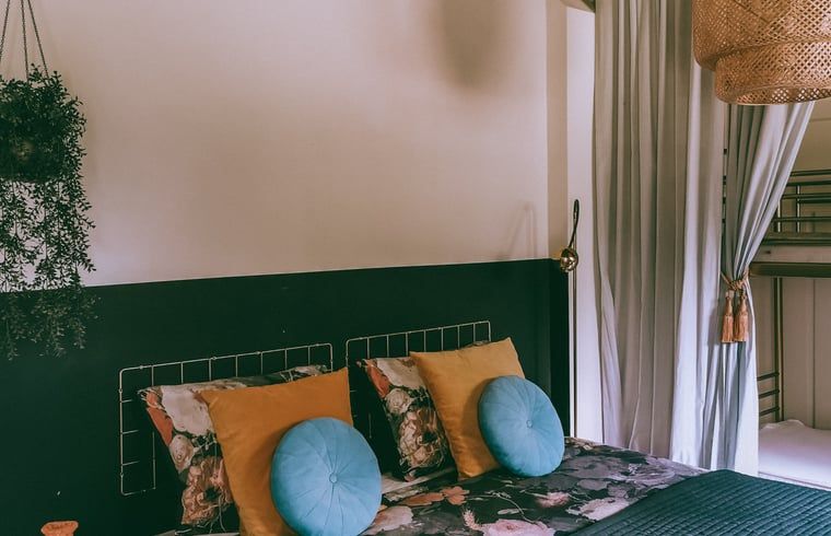 Attractive bedroom in cottage in Voorst, Oude IJsselstreek, Achterhoek, with vintage lamp and luxury bedding, ideal vacation home in Gelderland.