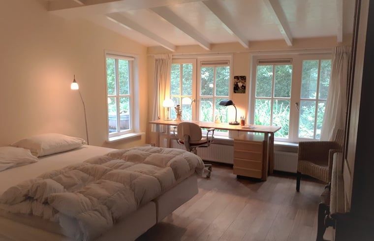 Attraktives Schlafzimmer im Ferienhaus in Joppe, Achterhoek, mit grossem Schreibtisch und Blick auf die gruene Natur in Gelderland.