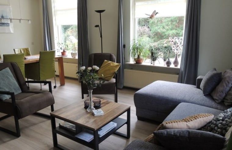 Cozy living room in Holiday Home in Winterswijk Corle, Achterhoek with lots of light and views of the green nature of Gelderland.