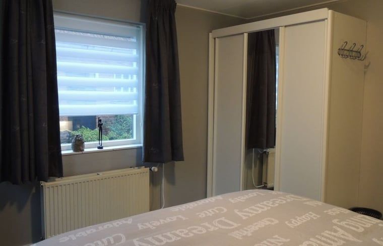 Bedroom in Holiday Home in Winterswijk Corle with modern decor and garden view in Achterhoek, Gelderland.