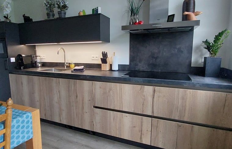Kitchen with wooden details in Holiday home in Winterswijk Corle, ideal for culinary lovers in Achterhoek, Gelderland.