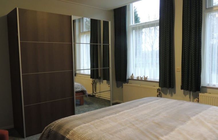 Bedroom with mirrored wardrobe in Holiday home in Winterswijk Corle, offers comfort in Achterhoek, Gelderland.
