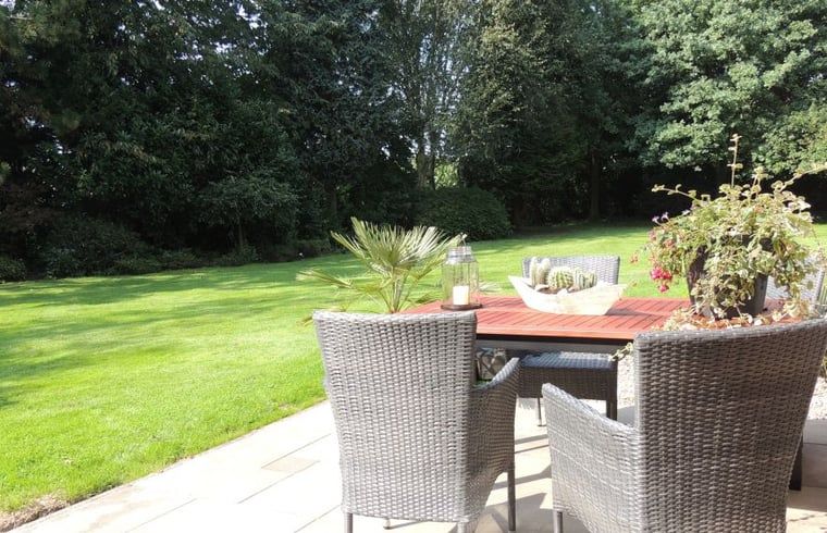 Outdoor terrace overlooking the garden at Holiday home in Winterswijk Corle, perfect for summer evenings in Achterhoek, Gelderland.