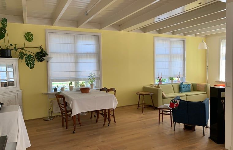 Cozy living room in Holiday home in Corle, Winterswijk Corle, with dining area and sitting area, perfect for family gatherings.