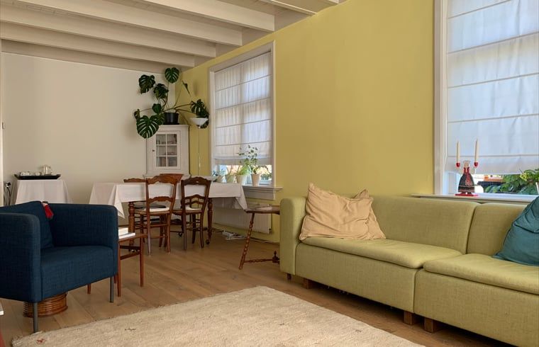 Comfortable sitting area in Holiday home in Corle, Winterswijk Corle, with bright interior and wooden floor in the Achterhoek.