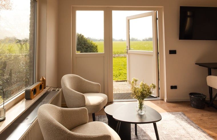 Cozy sitting area in cottage in Wilp-Achterhoek overlooking the green fields of Gelderland.