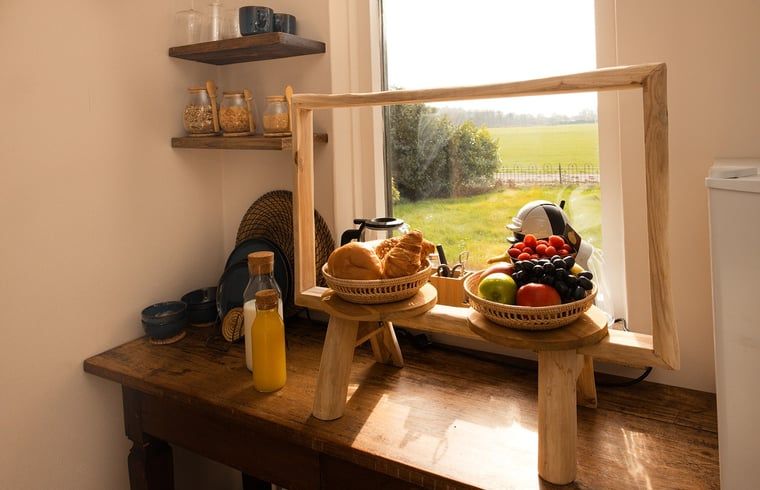 Breakfast Corner in Cottage in Wilp-Achterhoek with fresh fruit and rolls, countryside views.