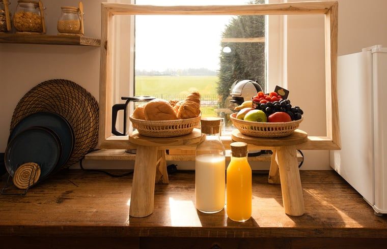 Cozy breakfast area in Holiday Home in Wilp-Achterhoek with milk and orange juice.