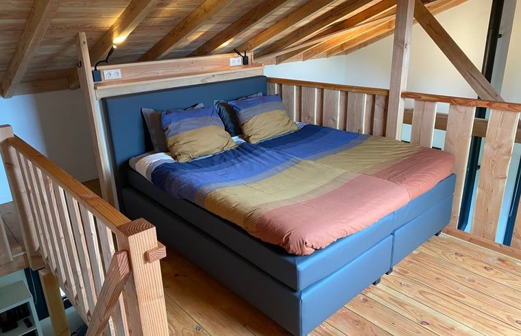 Knusse slaapkamer van Vakantiehuis in Empe, Gelderse vallei, Gelderland, met houten afwerking en comfortabele bedden.