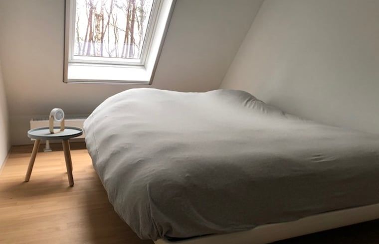 Schlafzimmer im Dachgeschoss eines Ferienhauses in Tonden, Gelderland, mit Dachfenster.