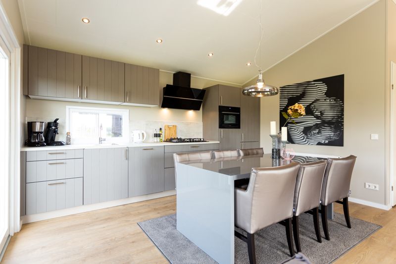 Modern kitchen at Leijhoeve 4 persons Wellness, vacation home in Beekbergen, Veluwe, Gelderland, with stylish interior and dining area.