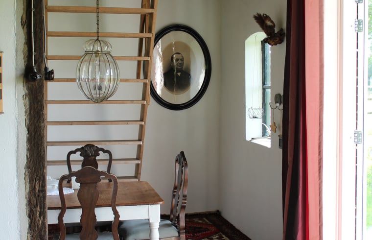 Knusse leeshoek in Huisje in Kootwijk, Veluwe, met antieke meubels en kunst.