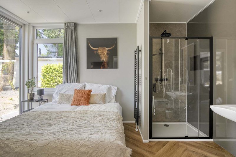 Comfortable bedroom in Veluwehoeve 4 persons MIVA, Ede, with spacious bed and views of the nature of the Veluwe.