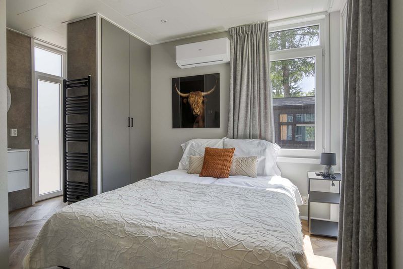 Cozy bedroom of Veluwehoeve 4 persons MIVA in Ede, Veluwe, with air conditioning and soothing decor.