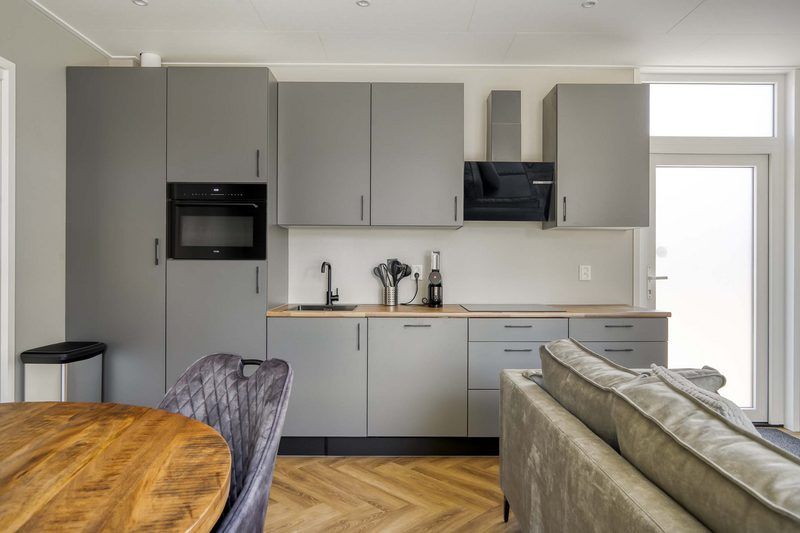 Kitchen of Veluwehoeve 4 persons MIVA in Ede, Veluwe, with sleek finishes and all the necessary equipment for a comfortable stay.
