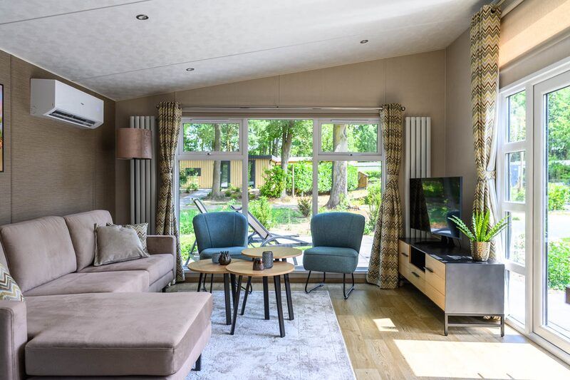 Cozy living room in Nova 4 persons Wellness vacation home in Ede, Veluwe, Gelderland with large window and view.