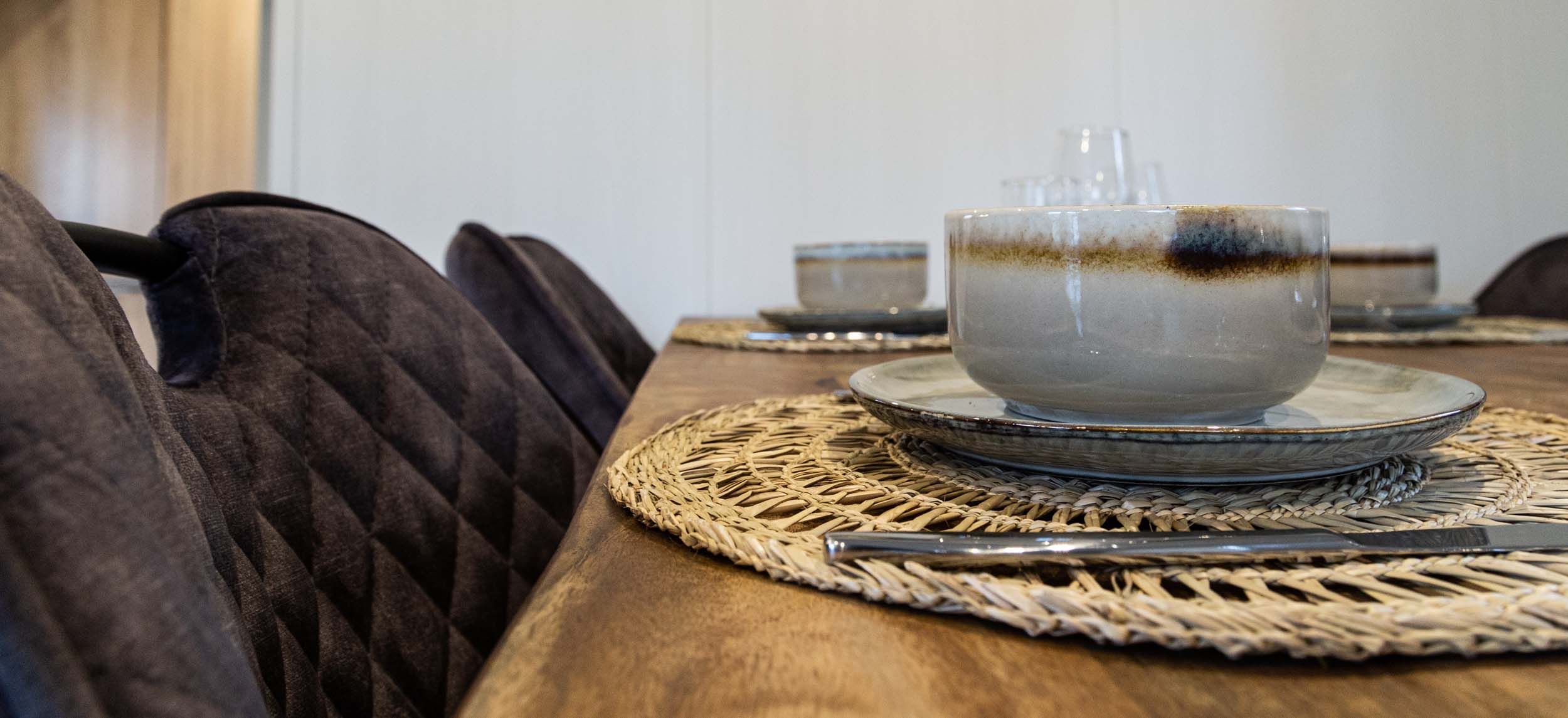 Cozy dining area in Luna vacation home, Ede, Veluwe, with set table.