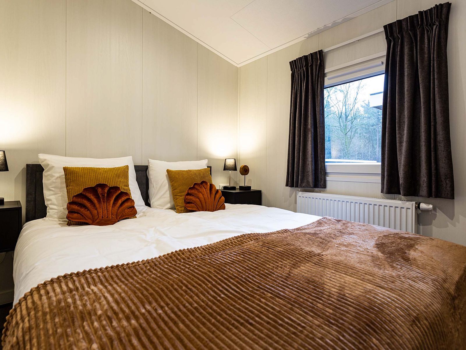 Spacious bedroom in Luna vacation home, Ede, Veluwe, with large windows and views.