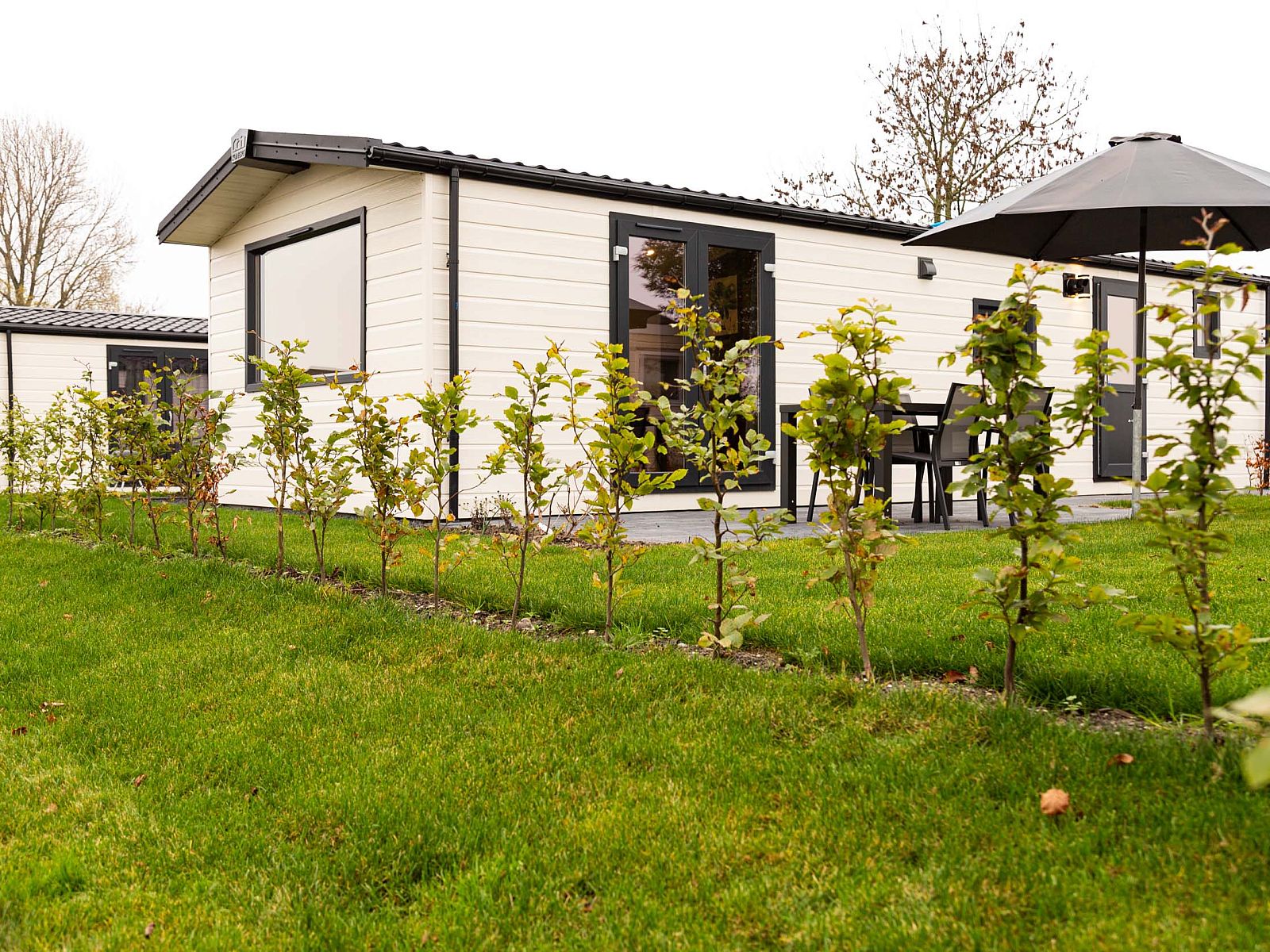 Exterior of Luna vacation home, Ede, Veluwe, with terrace and garden.