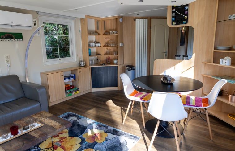 Stylish dining room in Holiday home in Emst, Gelderland, with wooden floor.